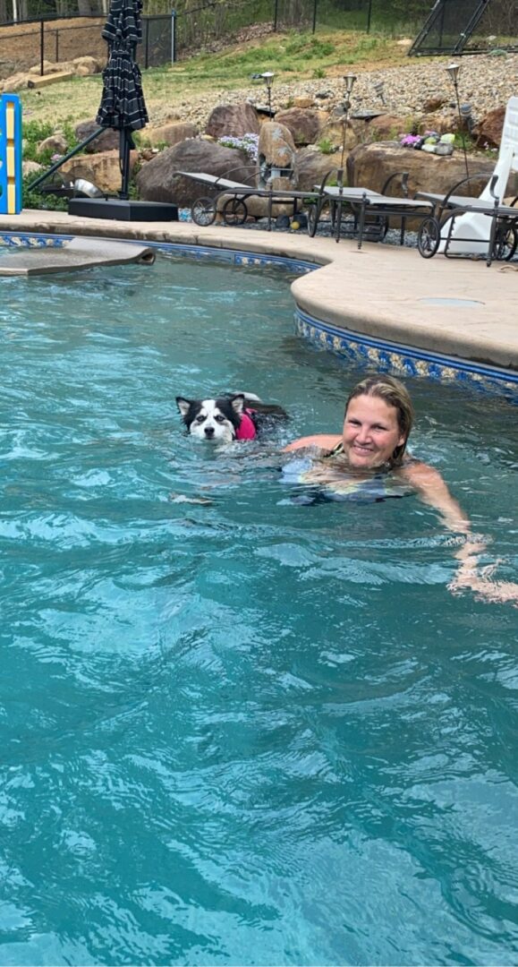 A woman and dog playing a pool