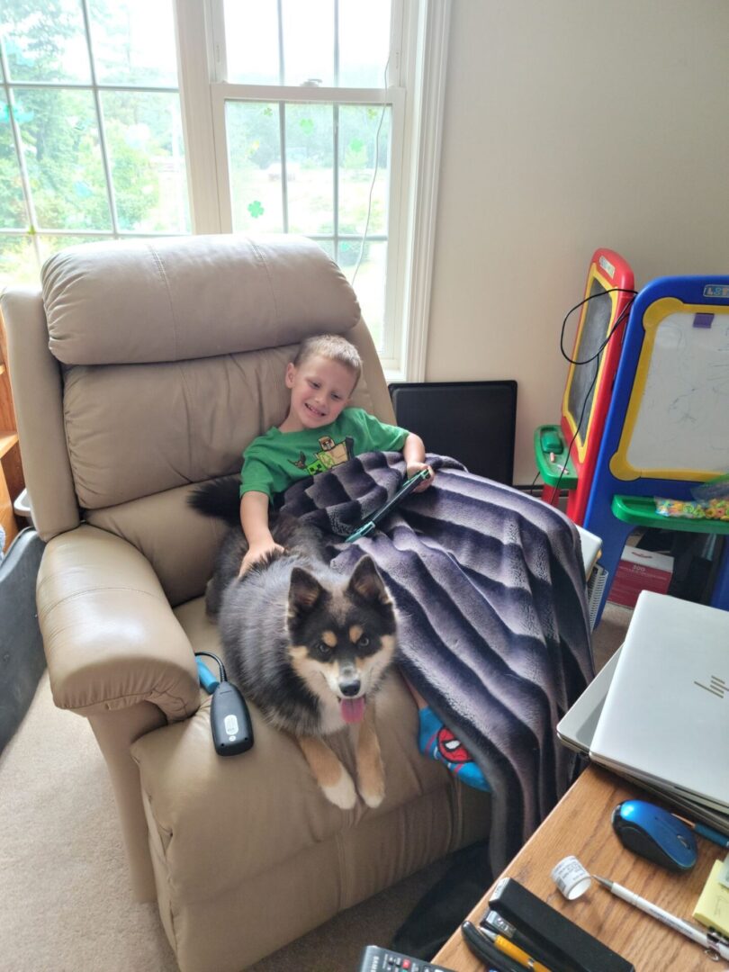 A boy and a dog in a sofa